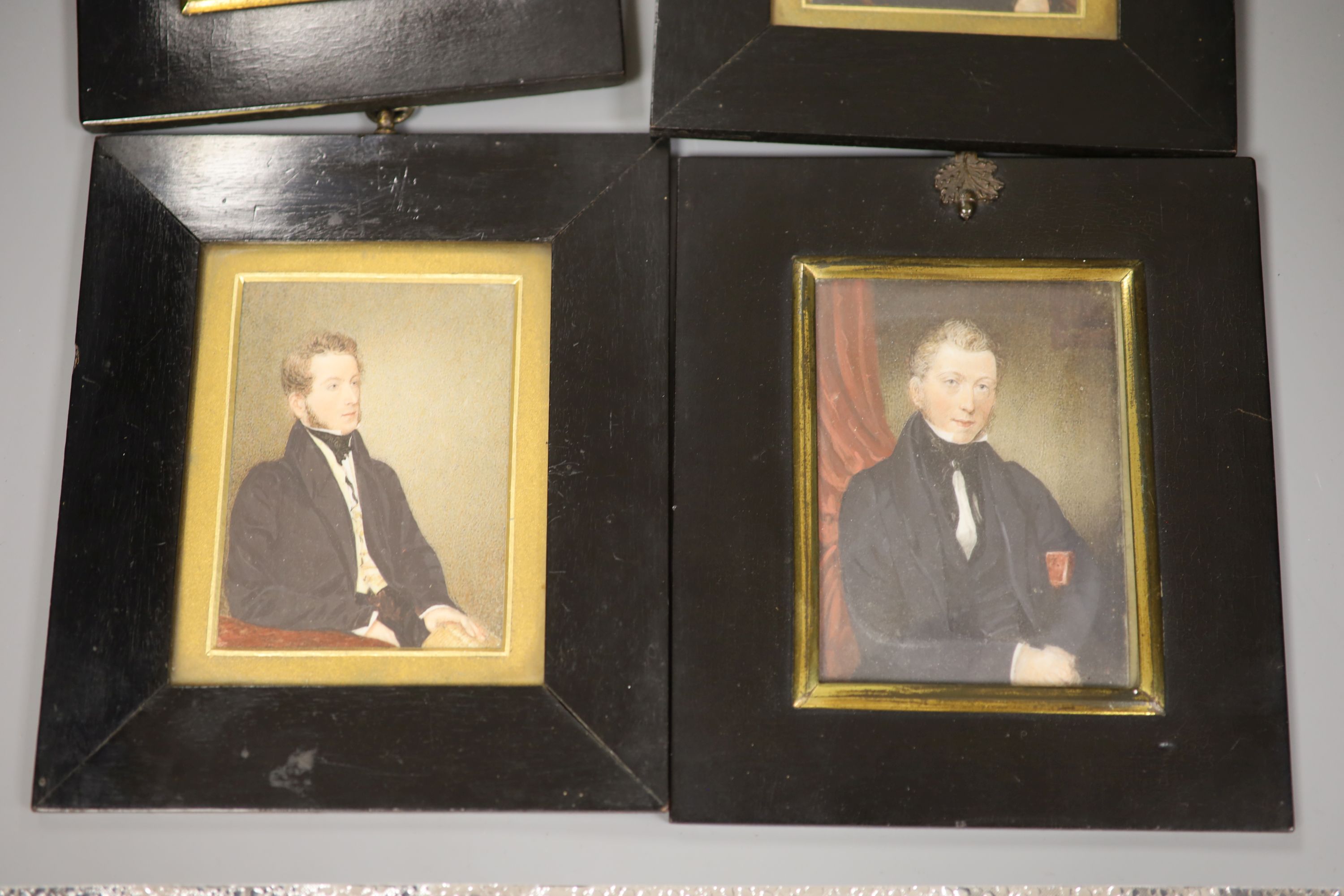 Four 19th century miniature portraits and a gilt-framed mirror, 26 x 29cm